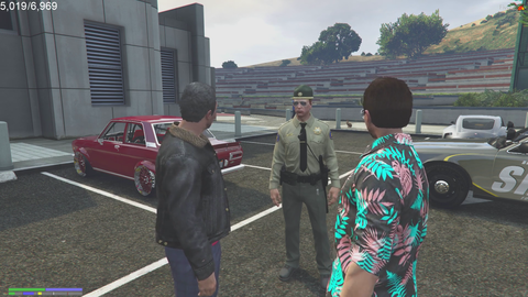 Cops looking for Avon and he's behind them talking on a cell phone.